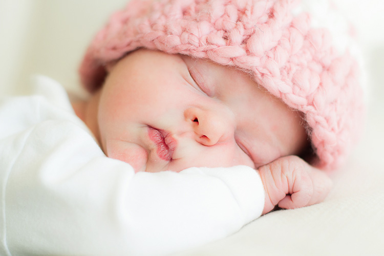 Newborn in pink hat